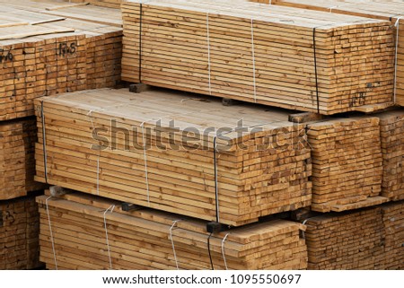 lumber in a large warehouse. Wooden boards in the stack