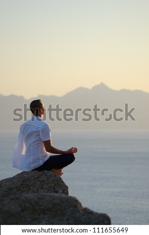 Man meditating by the sea