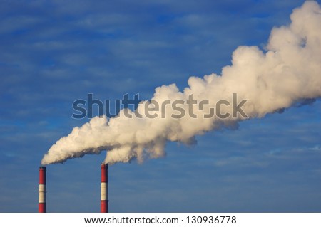 Pollution. Smoke from industrial chimneys against the blue sky