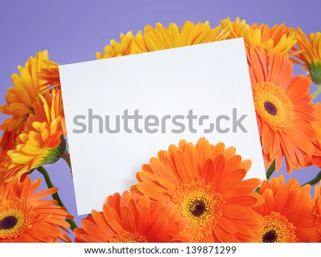 White sheet of paper with a message in the bouquet of orange flowers