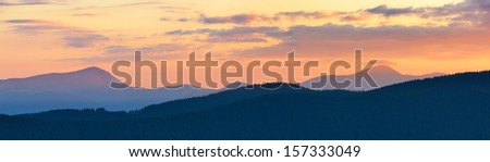 Evening landscape. Sunset panorama of mountains with a colorful sky. Carpathians, Ukraine