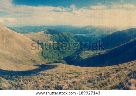 Sunny day in the mountains. Summer landscape with a mountain valley. Carpathians, Ukraine, Europe. Filtered image: vintage, grunge and texture effects