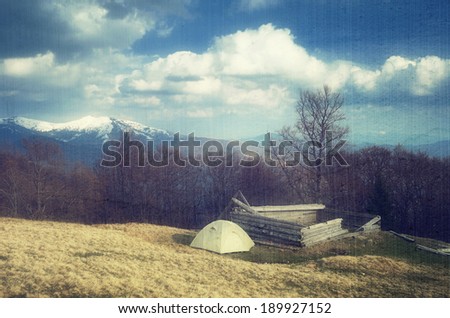 Spring landscape with the beautiful sky. Camping in the mountains. Carpathians, Ukraine, Europe. Filtered image: vintage, grunge and texture effects