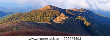 Autumn landscape with mountains. Panorama on a sunny afternoon. Beautiful fall forest