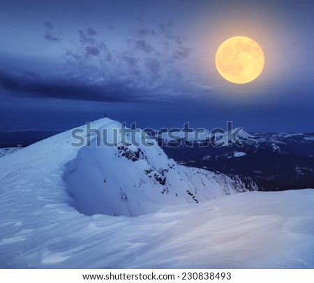 Winter landscape. The top of the rocky mountains. Night and the light of the full moon. Carpathian mountains, Ukraine, Europe