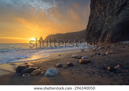Seascape with sunset. Evening by the sea. Beautiful rock on the shore. Crimea