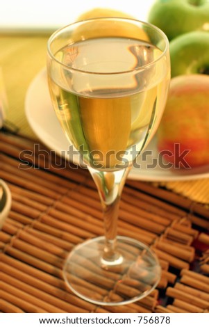 Soft focus shot of a glass of cider or fruit wine.