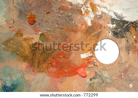 abstract background from a well used paint palette, clipping path for hole.