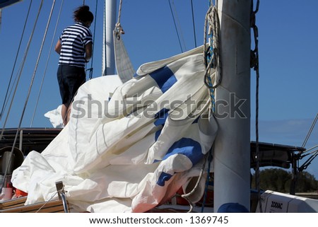a female crew member prepares for sail on a tall ship