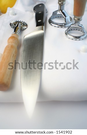 20mm lens shot of chef\'s uniform, ravioli and pastry cutters. Accentuated blur at base of image.