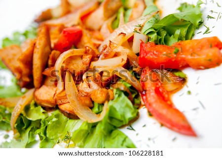 Meat stew with vegetables decorated leaf lettuce isolated on white background macro. A series of food in a restaurant close-up