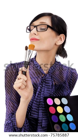 Brunette with cosmetic brushes and a palette of Isolated white background