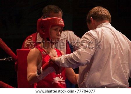 NOVOSIBIRSK - MAY 20: Russian Championship in women\'s boxing. The semi-final battle Referee checks readiness for battle  Gnevanova Svetlana on May 20, 2011, Novosibirsk Russia