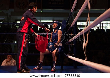 NOVOSIBIRSK - MAY 20: Russian Championship in women\'s boxing. The coach sets up and gives her instructions. Isaeva Zoya and her coach. on May 20, 2011, Novosibirsk Russia