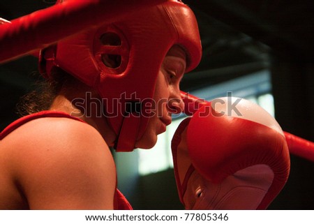 NOVOSIBIRSK - MAY 20: Russian Championship in women's boxing. The semi-final battle. The coach sets up and gives her instructions. Ochigava Sofia(red) and her coach on May 20, 2011, Novosibirsk Russia