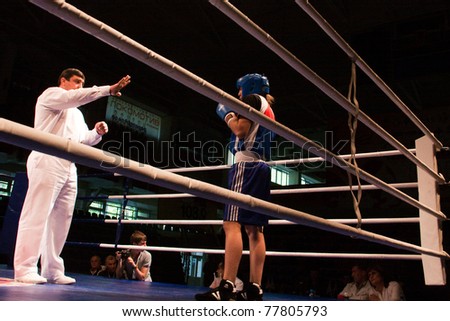 NOVOSIBIRSK - MAY 20: Russian Championship in women's boxing. The semi-final battle.  referee believes knockdown for Sablina Yuliya(blue) on May 20, 2011, Novosibirsk Russia