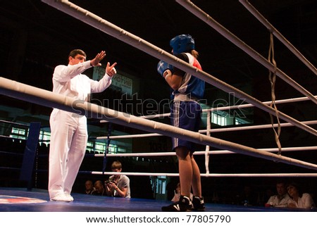 NOVOSIBIRSK - MAY 20: Russian Championship in women\'s boxing. The semi-final battle.  referee believes knockdown for Sablina Yuliya(blue) on May 20, 2011, Novosibirsk Russia