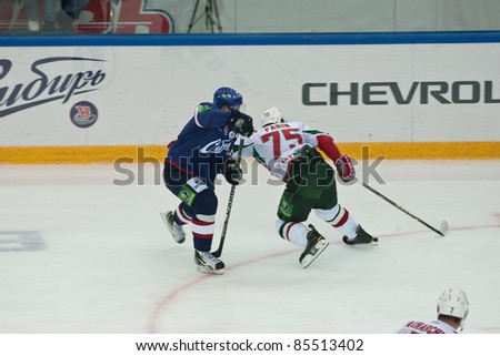 NOVOSIBIRSK - SEPTEMBER 26:  Ice hockey, the game between Siberia and AK Bars defender Gregory Panin (Ak Bars) pushes a player in Siberia to protect the puck on September 26, 2011, Novosibirsk Russia