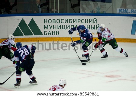 NOVOSIBIRSK - SEPTEMBER 26:  Ice hockey, game between Siberia and AK Bars forward Tereshchenko (Ak Bars) trying to prevent a throw forward Malyshev (Siberia) on September 26, 2011, Novosibirsk Russia