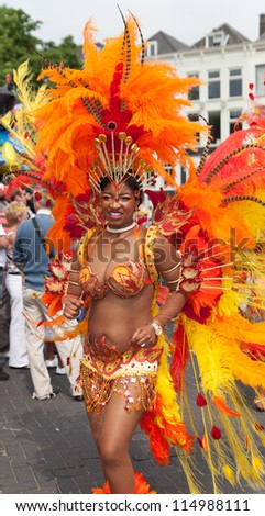 ROTTERDAM - JULY 28: Beautiful girl in a summer carnival parade on the 28th of July, 2012 in Rotterdam. The summer carnival is yearly event that attracts around 800.000 visitors.