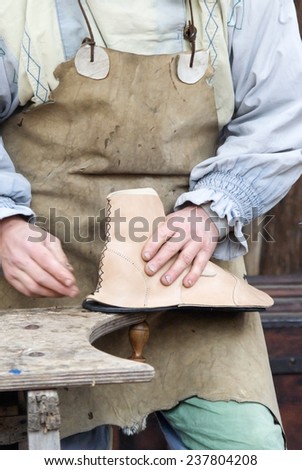 Leather craftsmen making shoes by hand