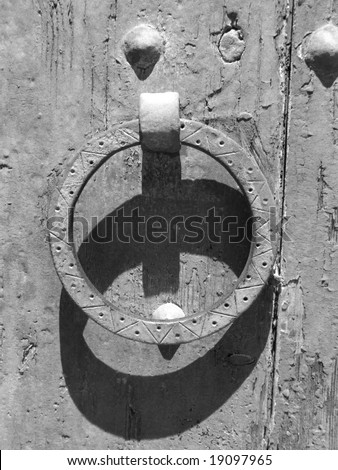 Rusty door knocker , vintage door closeup in black an white.