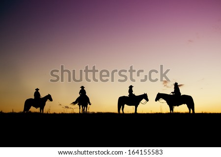 Cowboys And Cowgirl Silhouettes At Sunset