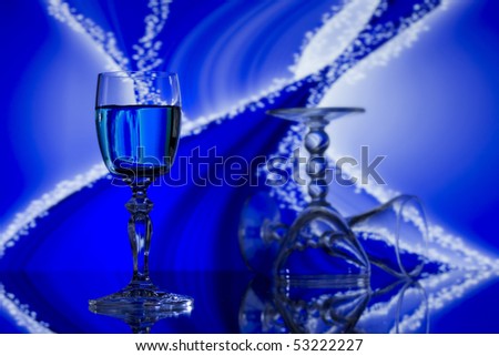Three wine glasses on blue and white sparkled and curved background