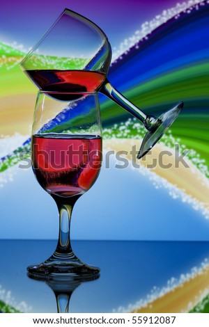 Two glasses of red wine on colorful swirl background
