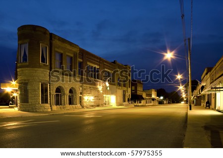 Night scene of small old town with street lights and dark blue sky