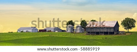 Colorful majestic farm behind green soy field