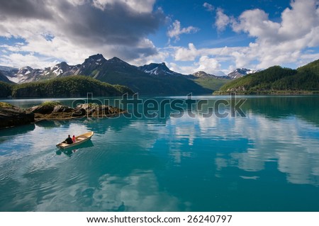 Small boat with two persons on Norwegian fjord