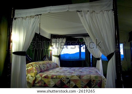 luxury bed on a serengeti national park safari lodge, tanzania