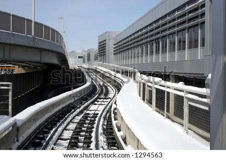 Monorail tram at the Minneapolis airport in winter with snow, vertical