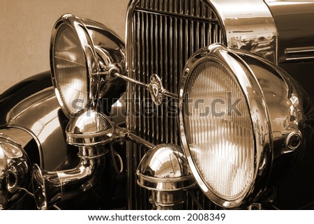 stock photo vintage roadster headlights and grill in sepia tone