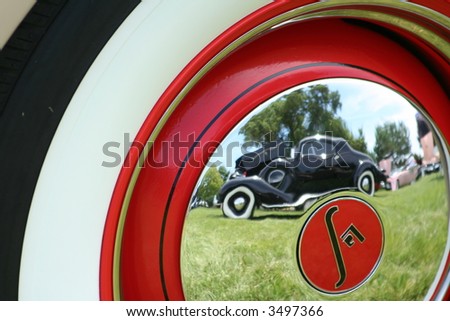 classic auto reflected in classic wheel