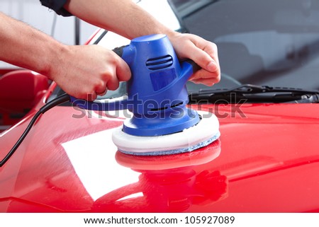 Hands with Auto polisher. Car repair service.