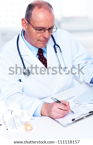 Medical doctor working with papers in the office.