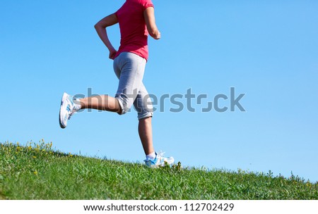 Young woman jogging in the park. Health and fitness.