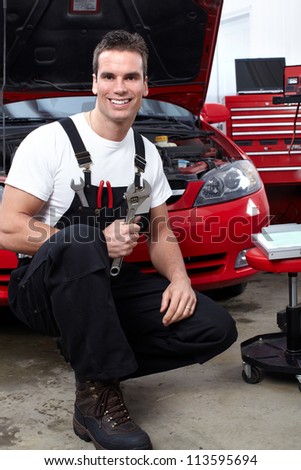 Auto mechanic with a wrench. Car repair service.