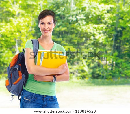 College Student girl with books in the park. Education.