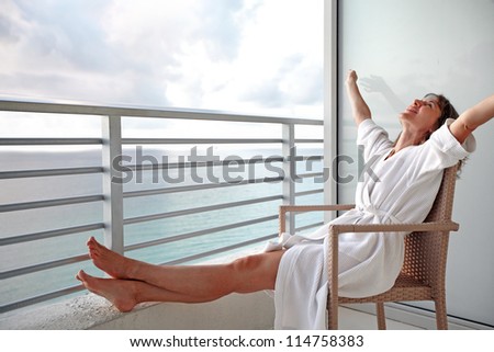 Happy woman looking on the ocean. Resort.