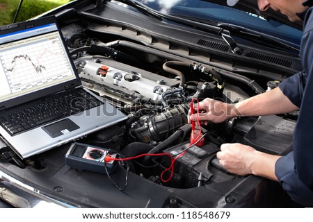 Professional Car Mechanic Working In Auto Repair Service.