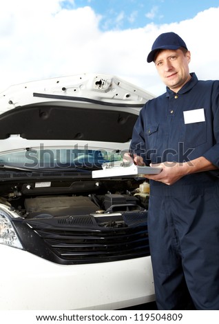 Car mechanic working in auto repair service.