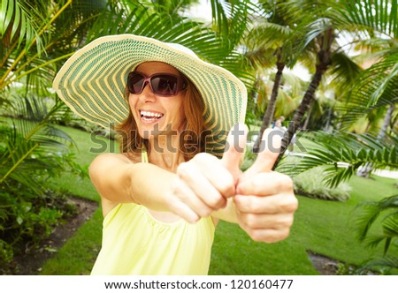 Happy woman in the tropical garden. Vacation.
