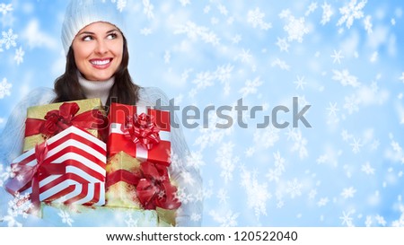 Beautiful Santa helper christmas girl with gifts on snowy background.