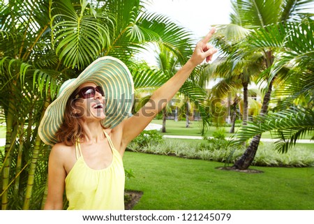 Woman in the tropical garden. Vacation.