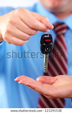 Hand with a car key. Isolated on white background.
