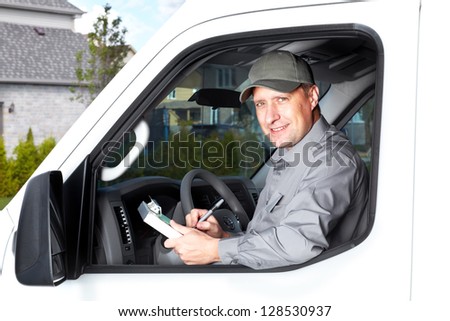 Smiling truck driver in the car. Delivery cargo service.