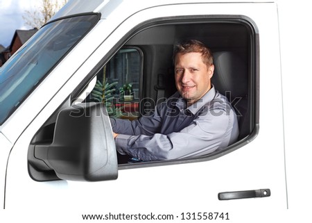 Smiling truck driver in the car. Delivery cargo service.